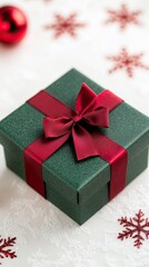 Wall Mural - Beautifully Wrapped Green Christmas Gift With Red Ribbon on Festive Background