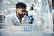 © peopleimages.com - Healthcare, man and scientist with microscope in lab of experiment research, medical data or studying bacteria. Researcher, check and biotechnology for pharmaceutical development of vaccine solution