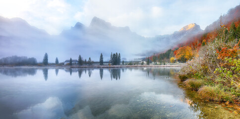 Wall Mural - captivating autumn scene of foggy and sunny morning on almsee lake.
