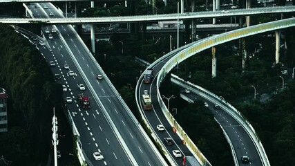 Canvas Print - Aerial view of city buildings and busy traffic overpass