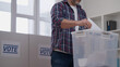 © Synthex🇺🇦 - Man making his choice during the presidential election, throwing a ballot into a container