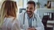 © inthasone - Portrait of smiling male doctor at medical office in hospital, showing examination results on laptop monitor screen and having consultation with young woman patient sitting in clinic.
