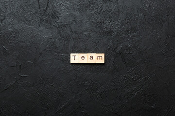 Wall Mural - team word written on wood block. team text on cement table for your desing, concept