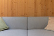 © Mint Images - Detail of modern couch against wood panel wall