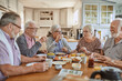 © Marko Geber - Diverse senior friends having breakfast together at home