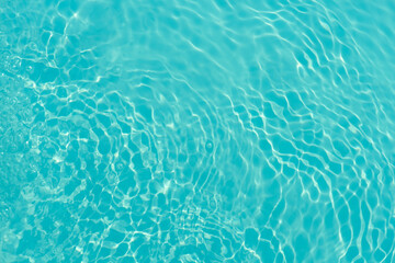 Sticker - Blue water with ripples on the surface. Defocus blurred transparent blue colored clear calm water surface texture with splashes and bubbles. Water waves with shining pattern texture background.