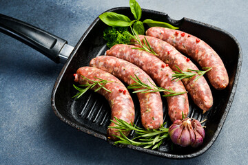 Wall Mural - Grill pan and homemade beef sausages ready to cook. Top view.