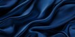 © Mona -33 Desing - Dark blue silk satin. Soft folds. Fabric. Navy blue luxury background.  Elegant background with space for design. Soft wavy folds. Navy Blue Silk Satin Background with Elegant Waves.
