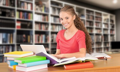 Canvas Print - Happy thinking woman student study in library