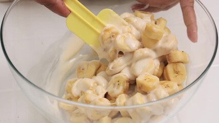 Wall Mural - Mixing Banana with Flour Batter, Process Making Banana Fritters