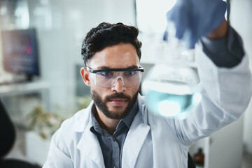 Wall Mural - Scientist, research and man with beaker in lab for inspection, medical and pharmaceutical study. Science, PPE and analysis of glass container for antiviral compound, investigation and chemistry test