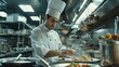 © raja - Chef in White Uniform Arranging Food on a Plate in a Restaurant Kitchen