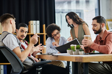 Wall Mural - Professionals engage in a serious discussion about their work.