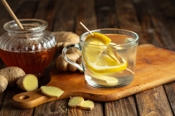 Wall Mural - Ginger tea with lemon and honey on a old wooden table.