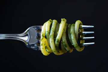 Poster - Pesto pasta twirled on a fork close-up