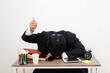 © ArvStd - Young tired exhausted asian employee businessman sit work sleep laid his head down on white office desk show thumb up gesture isolated on white background studio