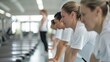 © Steveandfriend - Group of women engaged in indoor rowing exercise at a gym, promoting fitness, teamwork, and healthy lifestyle in a modern facility.