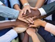 © Surachetsh - Professional business team in a close-up top view, hands stacked together to signify unity and teamwork.