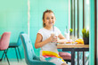© zulfiska - Cute girl drinking milkshake in cafe and having fun. Retro style.