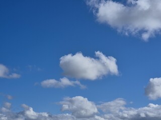 Wall Mural - Summer white fluffy cumulus clouds in the deep blue sky