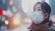 © Mini - Young Asian woman wearing N95 respiratory mask protect and filter pm2.5 or particulate matter against bad Air Pollution in City