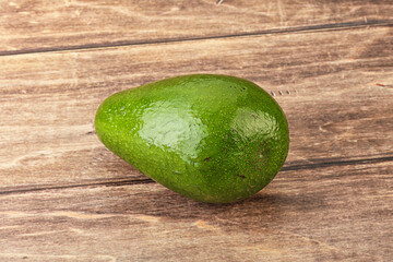 Wall Mural - Ripe green avocado over background