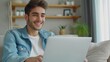 © Andrii  - Comfortable Living Room with Young Man and Laptop