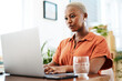 © peopleimages.com - Typing, online and black woman with laptop, office and thinking of ideas and copywriting. Writer, working and creative for website on desk, seriously and confident in company and reading of person