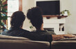 © peopleimages.com - Couple, home and television with hug, love and care together ready for a movie, tv show or web series. Back, living room and tech with streaming service or film subscription on a couch with people