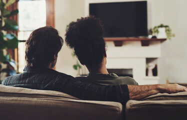 Sticker - Couple, home and television with hug, love and care together ready for a movie, tv show or web series. Back, living room and tech with streaming service or film subscription on a couch with people