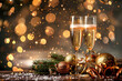 © Fotoksa - Two elegant champagne flutes sit amidst festive decorations and twinkling lights, creating a magical celebration. Happy New Year