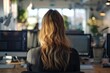 © Cloudyew - Professional woman from behind in a professional workspace.