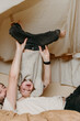 © Melissa Milis Photography/Stocksy - Fun dad and son play indoors