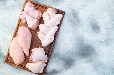 Poster - Raw mixed chicken meat parts  for cooking on rustic background