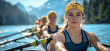 Focused female rower leading a team on a serene mountain lake under a clear sky. Ideal for concepts of teamwork, dedication, and outdoor sports.
