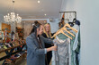© Rowena Naylor/Stocksy - LGBTQ couple shopping together in small independent store