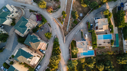 Aerial view of expensive residential houses in island small town Syvota Greece. American dream homes as example of real estate development in US suburbs