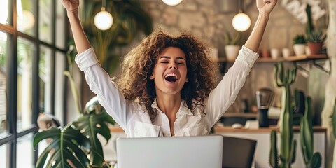 elated woman using laptop, office background, copy space 