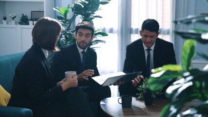 Wall Mural - Top view of diverse business team planning marketing strategy at meeting room. Professional manager thinking and analyze stock investment chart from laptop while colleague sharing idea. Directorate.