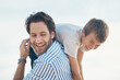 © Frank Coop/peopleimages.com - Father, happy and carrying on beach with boy, playful and laugh for travel, holiday and bonding as fun. Man, son and shoulder ride by ocean with support, love and care for trip, vacation and playing
