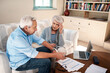 © Chanelle2000/peopleimages.com - Angry, old couple and laptop for finance, stress and argument with gambling debt. Apartment, pc and documents with man, woman and home loan with inflation, bankruptcy and taxes with mortgage payment