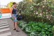 © Diego Martin/Stocksy - Mature Woman Gardening in Backyard on Summer Day