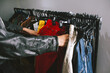 © Laura Herrera/Stocksy - woman browsing vintage clothing in store