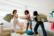 © BONNINSTUDIO/Stocksy - Joyful friends engaged in playful pillow fight