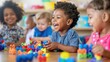 © GulArt - Closeup diverse little kids playing with colorful educational toys on blurred kindergarten room background