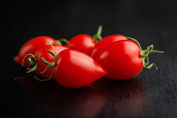 Sticker - Red cherry tomatoes on black table.