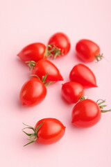 Wall Mural - Red cherry tomatoes on pink background.