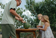 © Anna Artemenko/Stocksy - father cuts watermelon for children