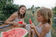 © Anna Artemenko/Stocksy - woman with little daughter eating watermelon