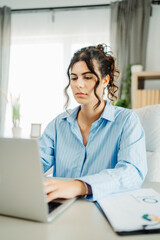 Wall Mural - Young caucasian business woman working in office on laptop